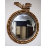 A 20th century gilt framed circular wall mirror with eagle surmount Condition Report:Available