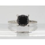 A white metal ring set with estimated approx 2ct black diamond, with  further white diamonds to