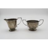 A silver sugar bowl and cream jug, of faceted form, by Mappin & Webb, Birmingham 1938, 236gms (2)