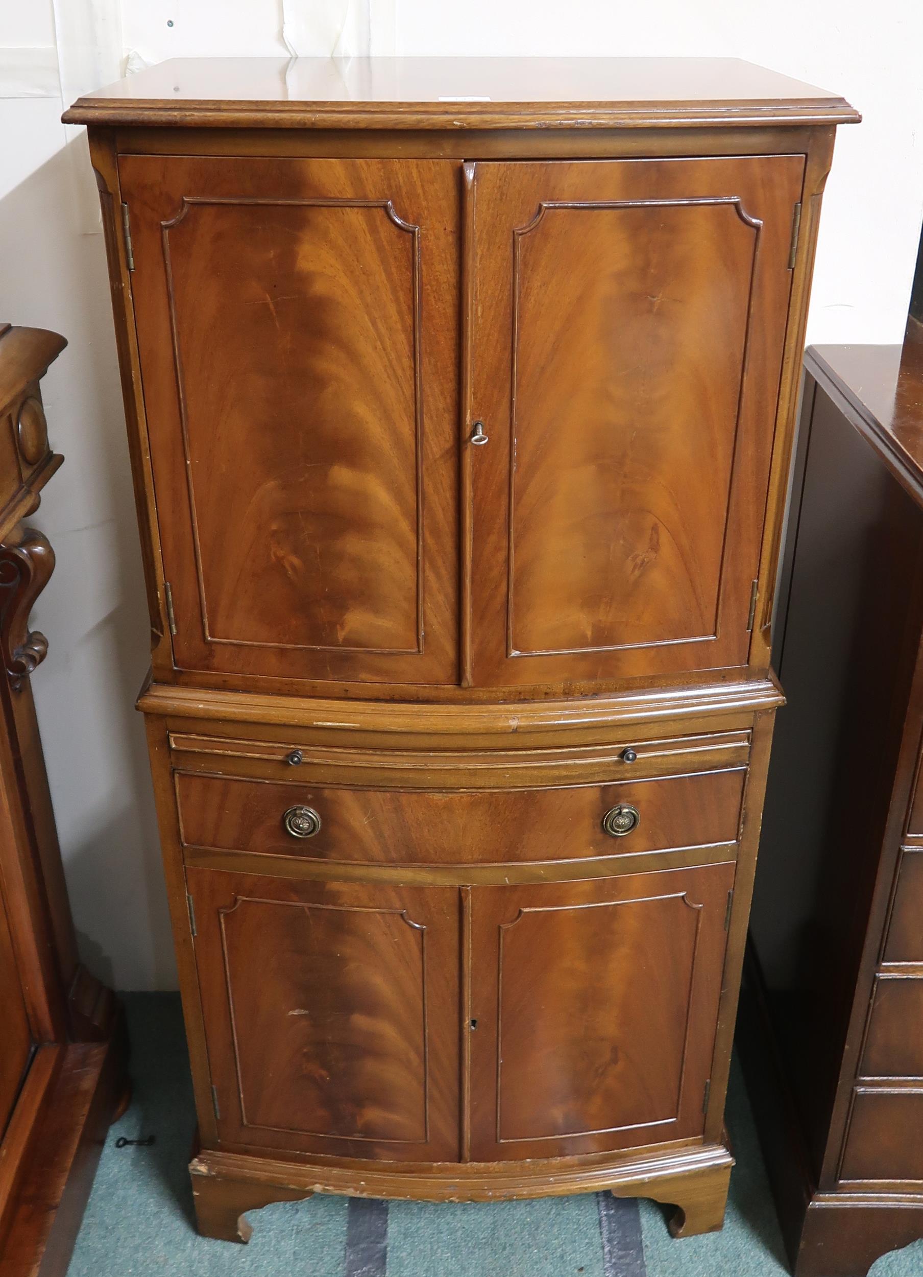 A 20th century mahogany bow front drinks cabinet, 129cm high x 62cm wide x 44cm deep Condition