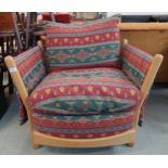 A contemporary elm and beech Ercol open armchair with Kilim style upholstery Condition Report: