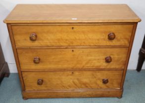 A Victorian pine three drawer chest with turned handles on bun feet, 92cm high x 111cm wide x 45cm