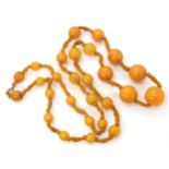 A string of amber coloured beads, largest bead 18.9mm x 17.9mm, weight 39.2gms Condition Report: