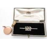 A 9ct white gold bar brooch with a pearl set gothic 'M' initial, a 9ct vintage locket weight