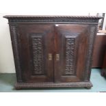 A Victorian stained oak two door cabinet, 133cm high x 148cm wide x 58cm deep Condition Report: