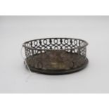 A George III silver wine coaster, with pierced looping gallery, gadrooned rim and wooden base,