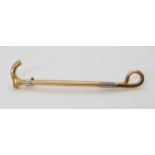 A 15ct gold walking stick shaped brooch, length 6.6cm, weight 6.1gms Condition Report:Available upon