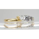 An 18ct gold three stone diamond ring set with estimated approx 1.20cts in total, in a pretty leaf