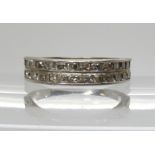 A white metal double row half eternity ring set with step cut diamonds, to an estimated approx total
