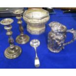 A collection of EPNS including a pair of candlesticks, a lidded jug with repousse bacchanlian