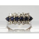 An 18ct gold sapphire and diamond cluster ring, set with two rows of brilliant cut diamonds with