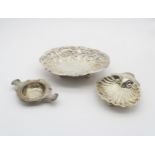 A late Victorian silver dish, the body lobed and with embossed floral decoration, on four ball feet,