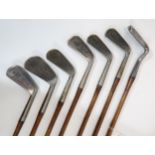 SEVEN GOLF IRONS comprising;5 Mashie, Taylor Mashie, 4 iron, 1 iron, 2 iron, 3 iron and 6 iron