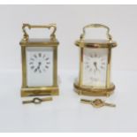 A French brass and glass cased carriage clock, and a Woodford brass and glass cased oval shaped