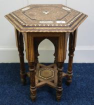 A late 19th century Moorish hexagonal table inlaid with assorted sample woods and mother of pearl,