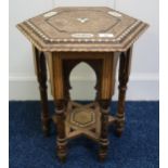 A late 19th century Moorish hexagonal table inlaid with assorted sample woods and mother of pearl,