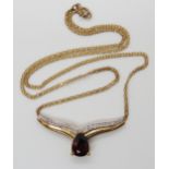 A 9ct gold garnet and diamond accent necklet, length of chain 41cm, gemset area approx 3.5cm, weight