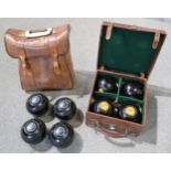 TWO SETS OF LAWN BOWLS one hardwood the other composition Condition Report:Available upon request