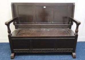 A 20th century stained oak monks bench, 99cm high x 131cm wide x 49cm deep Condition Report: