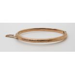 A 9ct gold bangle, with engraved design, weight 7.5gms Condition Report:Available upon request