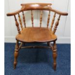 A 20th century spindle back captains chair, a 20th century beech spinning wheel and a wood bound