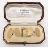 A set of 9ct gold oval engine turned cufflinks in original box and a 9ct gold watch strap buckle