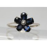 An 18k white gold sapphire flower ring, with diamond accent, size N1/2, weight 2.2gms Condition