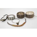 Two Chinese white metal repoussé bangles, with animal and foliage designs, a silver bracelet set
