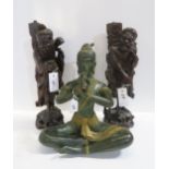 Two carved hardwood lamps and bronze tibetan figure of a crossed legged woman plating a pipe
