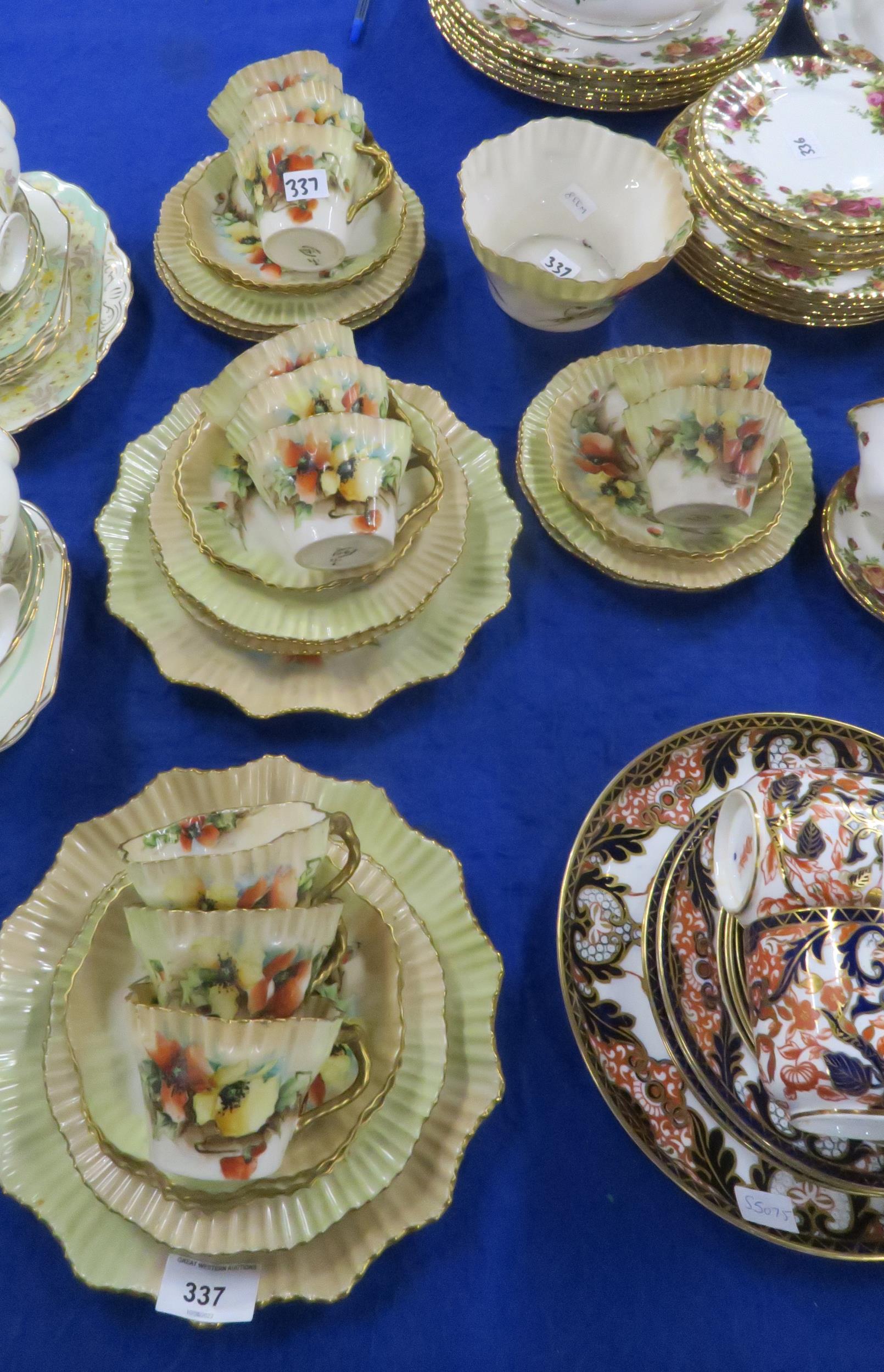 A Nautilus porcelain teaset painted with poppies, comprising eleven plates, cups and saucers, and