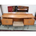 A mid 20th century teak G Plan E Gomme mirror back dressing table, cream vinyl dressing stool and