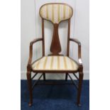 An Edwardian mahogany high back armchair on stretchered cabriole supports, 108cm high Condition