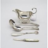 a collecting of silver including a silver sauce boat, with a flying scroll handle, by Adie