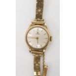 A 9ct gold ladies Tissot watch and strap, weight including mechanism 16.4gms Condition Report: