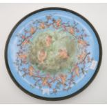 A large ceramic charger painted with cherubs, dated 1883 Condition Report:Not available for this