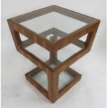 A contemporary teak and glass three tiered occasional table, 55cm high x 43cm wide x 43cm deep