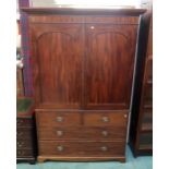 A Victorian mahogany linen press with corniced top above two panel doors above two short faux