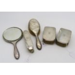 Assorted silver vanity set items, including a hand mirror and hair brush by J & R Griffin, Chester