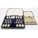 A cased set of twelve tea spoons and sugar tongs, with shaped terminals, by Cooper Brothers &