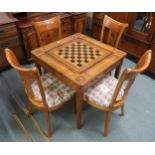 A 20th century games/bridge table with four accompanying chairs each with pierced splat bearing card