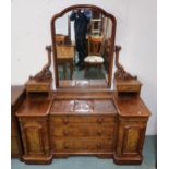 A Victorian walnut mirror back dressing chest with three central drawers flanked by cabinet doors,