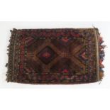 A multicoloured ground hand knotted tribal saddle bag, 110cm high x 62cm wide Condition Report: