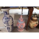 Tw large decorative urns and covers and a Chinese style blue and white vase Condition Report:Not