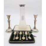A collection of silver including a pair of silver candle sticks, of tapering form with stepped