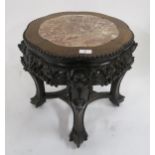 An Oriental hardwood marble topped occasional table with carved friezes on shaped supports Condition