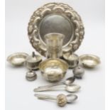 A collection of Indian white metal and EPNS items, including a repousse decorated tray and finger
