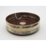 A boxed silver wine coaster, with turned wooden base and a blank circular cartouche, by Mappin &