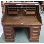 An early 20th century oak tambour topped writing desk with fitted interior over single drawer