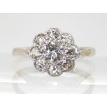 AN OLD CUT DIAMOND FLOWER RING mounted throughout in 18ct white gold and platinum, the central