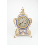 A FRENCH PORCELAIN ROCOCO STYLE CHIMING CLOCK the silvered dial with Roman numerals, within a gilt